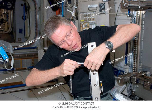 NASA astronaut Mike Fossum, Expedition 28 flight engineer, performs in-flight maintenance on the Muscle Atrophy Research Exercise System (MARES) in the Columbus...