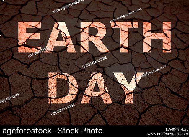 Earth Day text on dry cracked soil