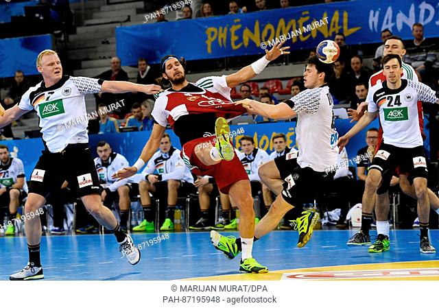 Germany's Patrick Wiencek (L) and Simon Ernst in action against Hungary's Laszlo Nagy (C) during the men's handball World Cup fixture between Germany and...