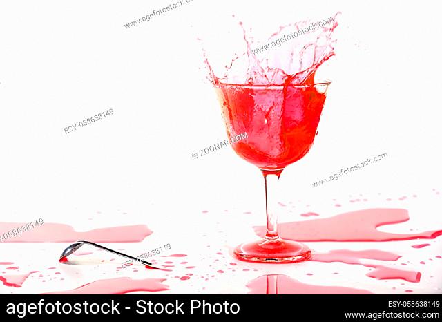 Red alcohol cocktail drink splash on white background