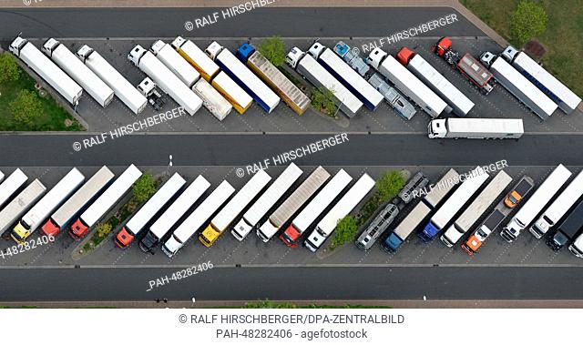 The full truck parking lot at the rest stop is picture from the air in Michendorf,  Germany, 01 May 2014. Photo: RALF HIRSCHBERGER/dpa | usage worldwide