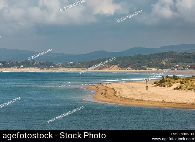 People enjoying a summer day on a beach in Santander, Spain