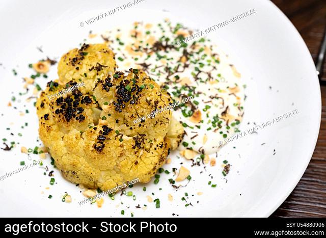 Roasted Cauliflower with Parmesan and Hazelnut topping with spring onion and cauliflower soup, gourmet international cuisine recipe