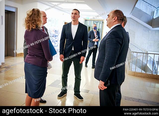 01 April 2022, Berlin: Former world boxing champion Wladimir Klitschko (M) chats with state secretaries and delegation members while waiting to meet the German...