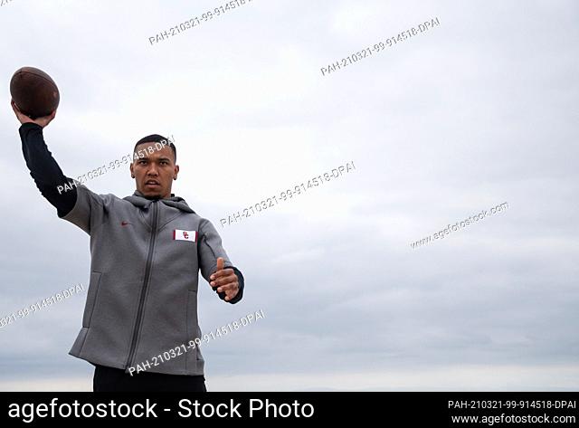 FILED - 09 February 2021, US, Newport Beach: Amon-Ra St. Brown throws a football on the beach. The American football player from the University of Southern...