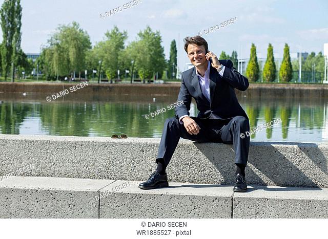 Businessman Using Mobile Phone, Munich, Bavaria, Germany