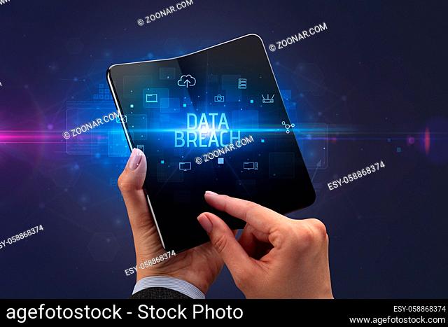 Businessman holding a foldable smartphone with DATA BREACH inscription, cyber security concept