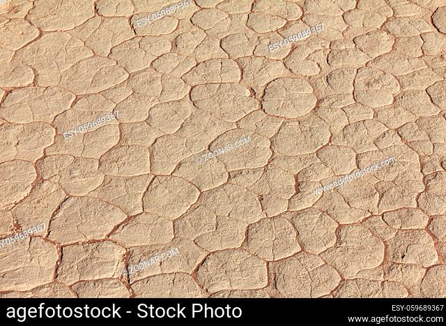 Clay texture of drying prism desiccation cracks in ground. Cracked and dried mud dirt background texture in the desert