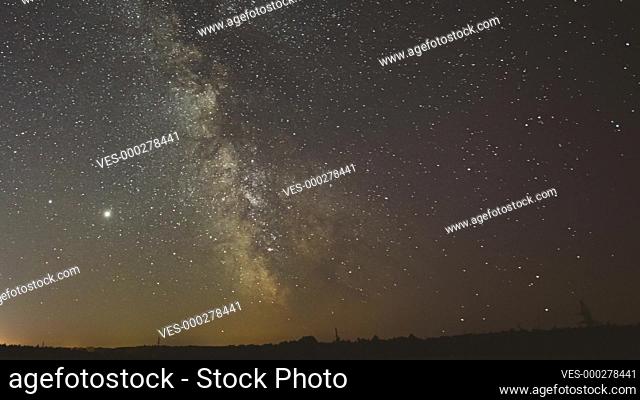 Night Starry Sky With Glowing Stars. Bright Glow Of Planets Saturn and Jupiter In Sky Among The Milky Way Galaxy Stars. Sky In Lights Of Sunset Dawn