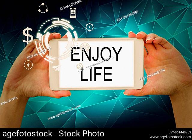Text sign showing Enjoy Life, Business overview Any thing, place, food or person, that makes you relax and happy Hands holding tablet presenting innovative...