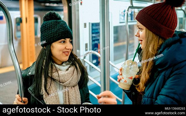 Two girls ride the New York subway - travel photography