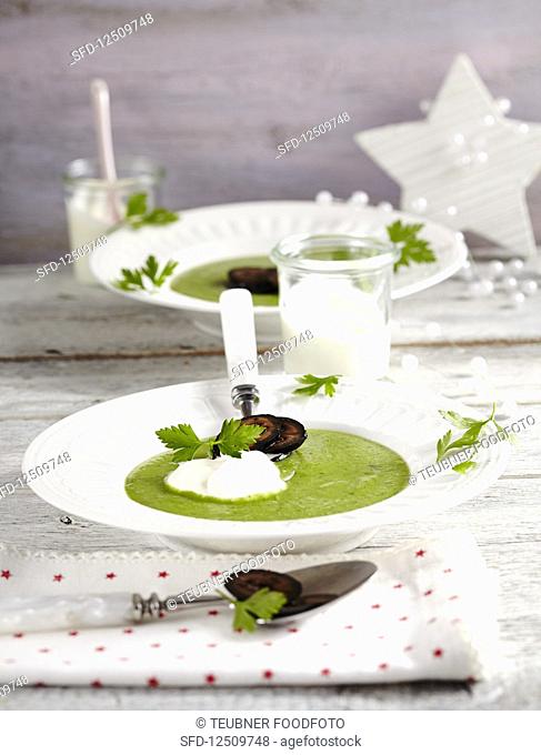 Pea and parsley soup with candied walnuts and crème fraîche