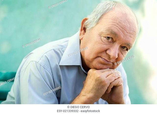 Portrait of sad bald senior man looking at camera