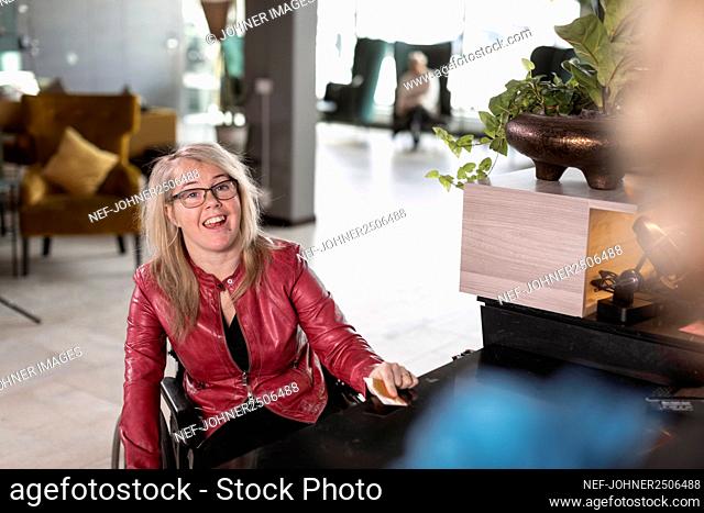 Woman on wheelchair in hotel lobby