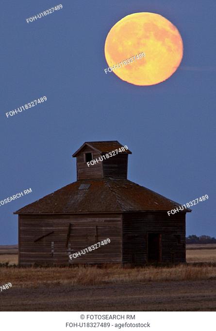full moon over old barn weathered wood farm