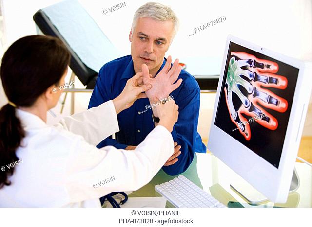 Doctor examining the hand of a patient