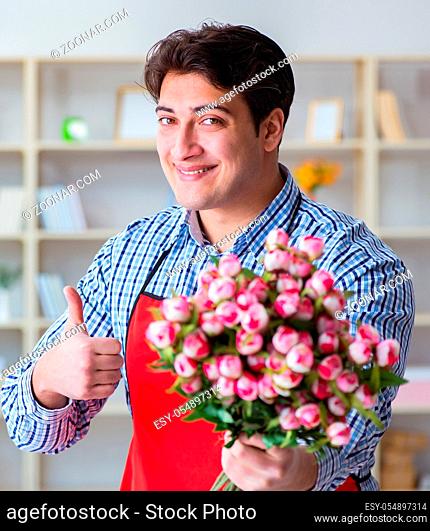 The flower shop assistant offering a bunch of flowers