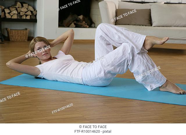 A woman lying on the floor and exercising