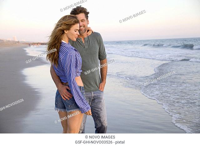 Three-Quarter Length Portrait of Mid-Adult Couple Standing at Beach