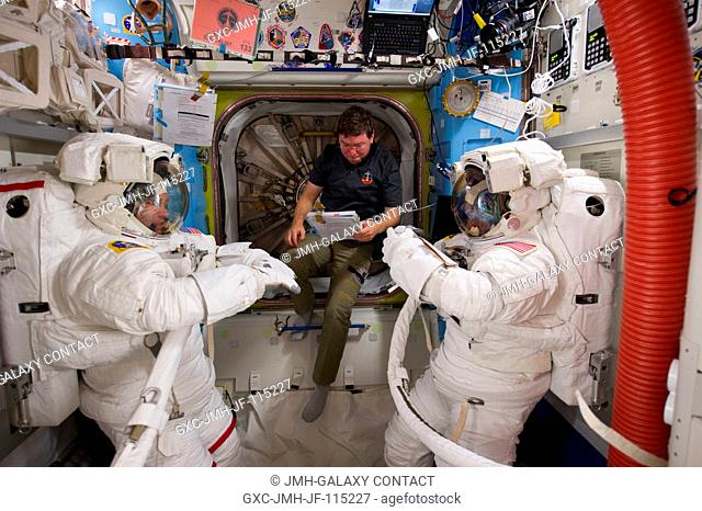 NASA astronauts Steve Bowen (left), Michael Barratt (center) and Alvin Drew, all STS-133 mission specialists, are pictured in the Quest airlock of the...