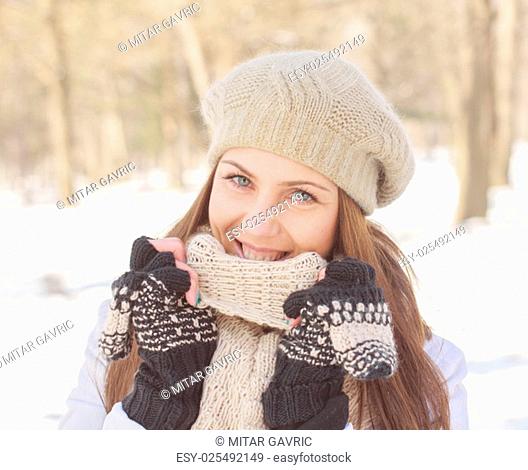 Beautiful Smiling Girl Winter in the park.Caucasian female winter portrait outdoor