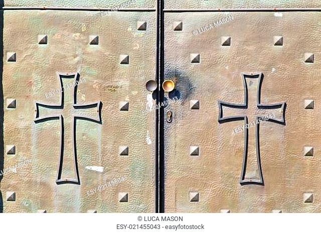 italy  patch lombardy    cross castellanza blur   abstract   rusty brass brown knocker in a  door curch  closed wood