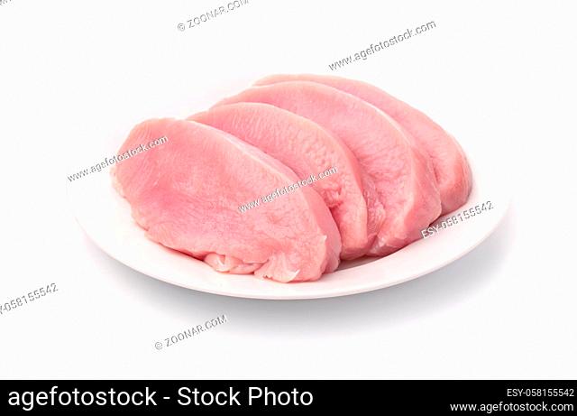 Fresh raw turkey meat fillet on ceramic plate isolated on white