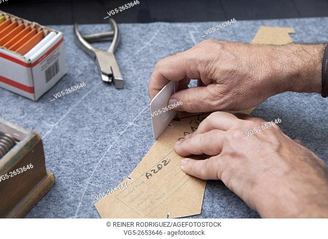 At a tailor in Barcelona, Spain. Production process of suit tailoring. drawing the outline of parts of a tailored jacket