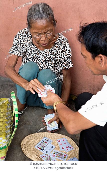 A Filipino fortune-teller reading into the cards on the sidewalk  Cebu City, Cebu, Visayas, Philippines