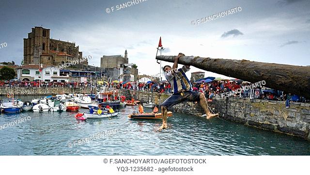 Greasy pole event at port, Castro Urdiales, Cantabria, Spain