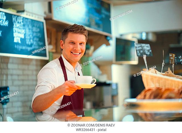 Smiling barista on the counter