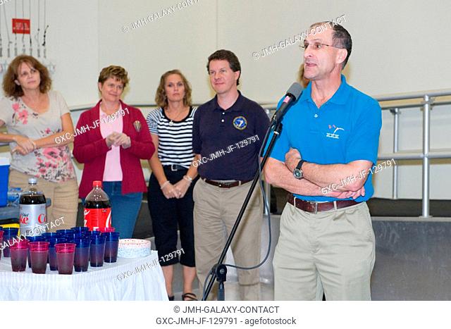 NASA astronaut Don Pettit, Expedition 3031 flight engineer, speaks to a crowd during a cake-cutting ceremony in the Jake Garn Simulation and Training Facility...