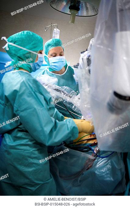 Reportage in an operating theatre during a hysterectomy using the da Vinci robot®. A nurse and the surgeon position the robot?s mechanical arm