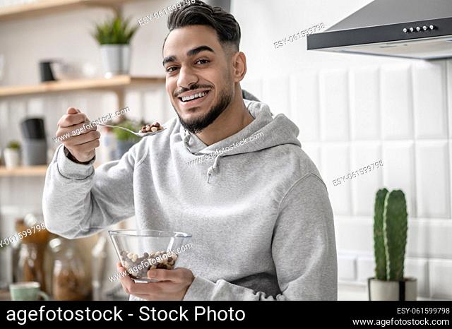 In the kitchen. A young man spending morning at home and having coffee