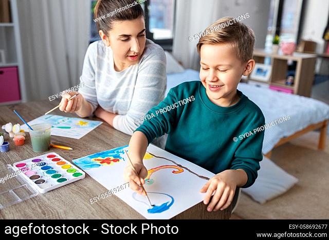mother and son with colors drawing at home