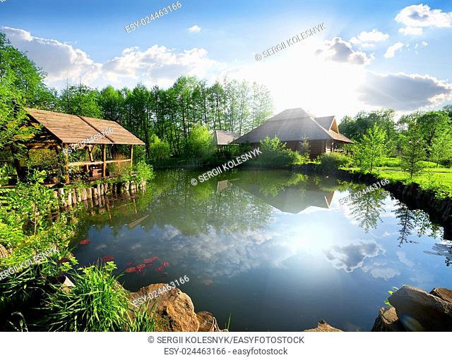 Wooden cottage near lake at sunny day