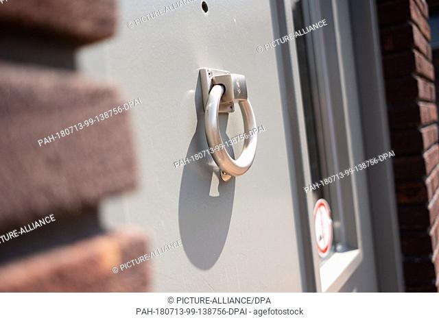 12 July 2018, Netherlands, Ter Apel: A door knocker hanging on a door of unoccupied accomodation instead of a bell at the main reception centre for asylum...