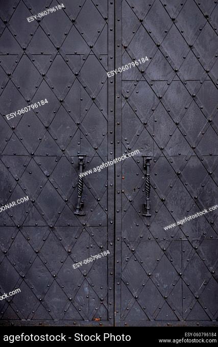 old black metal gate of a house with romboid pattern, grounge texture