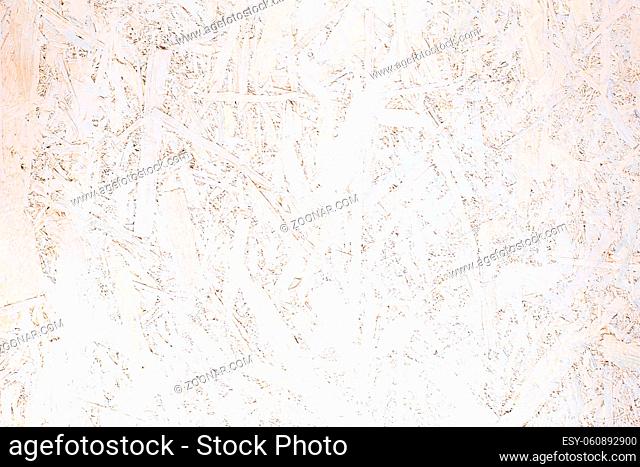 OSB panel texture. Oriented Strand Board. Chipboard building material. OSB wooden panel made of pressed sandy brown wood shavings as background closeup