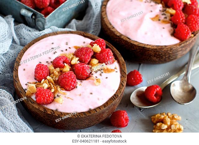 Raspberries smoothie bowls topped with fresh raspberries