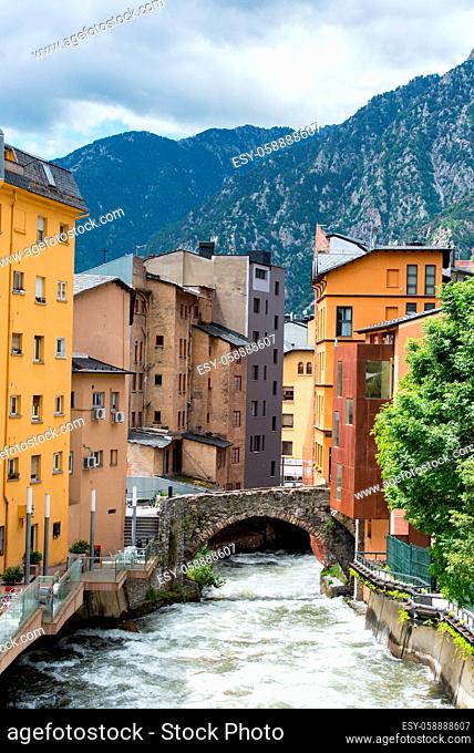 ESCALDES-ENGORDANY, ANDORRA - 2020 juny 8: River Valira on Engordany Bridge and houses view in a snowfall day in small town Escaldes-Engordany in Andorra on...
