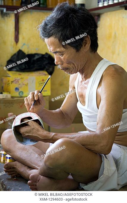 craftsman making masks  Hoi An, Vietnam, Asia
