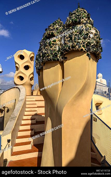 Chimneys in the shape of warrior soldiers on the rooftop terrace of Casa Milá  - La Pedrera covered with trencadis made of glass bottles designed by Gaudí...