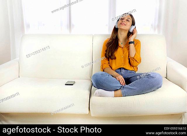 Stay safe, stay healthy. Teenager girl relaxing listening to music at home. Copy space