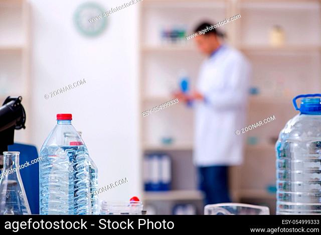 The young male chemist experimenting in lab