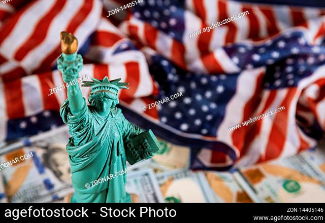 The Statue of Liberty the United States a symbol of freedom and democracy with flag of the United States of America US dollar bills