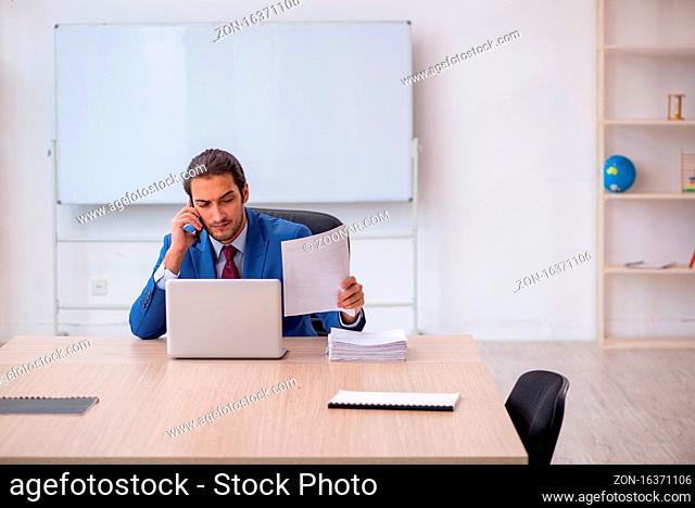 Young employee sitting in the office in front of whiteboard