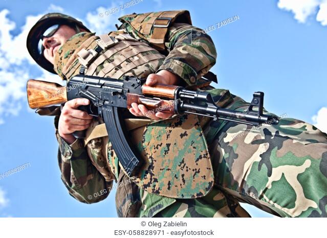 soldier in bulletproof vest with ak-47 rifle