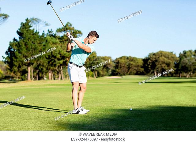 Concentrated golfer man taking shot