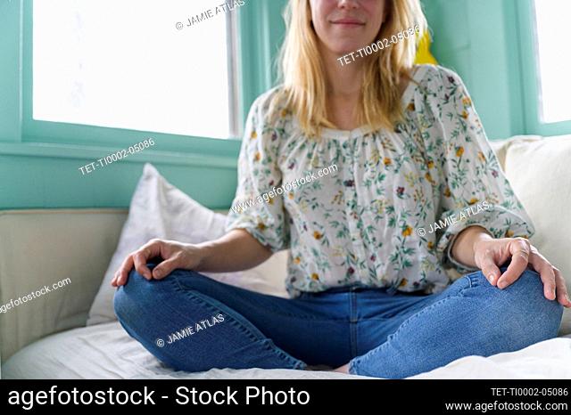 Woman sitting on bed